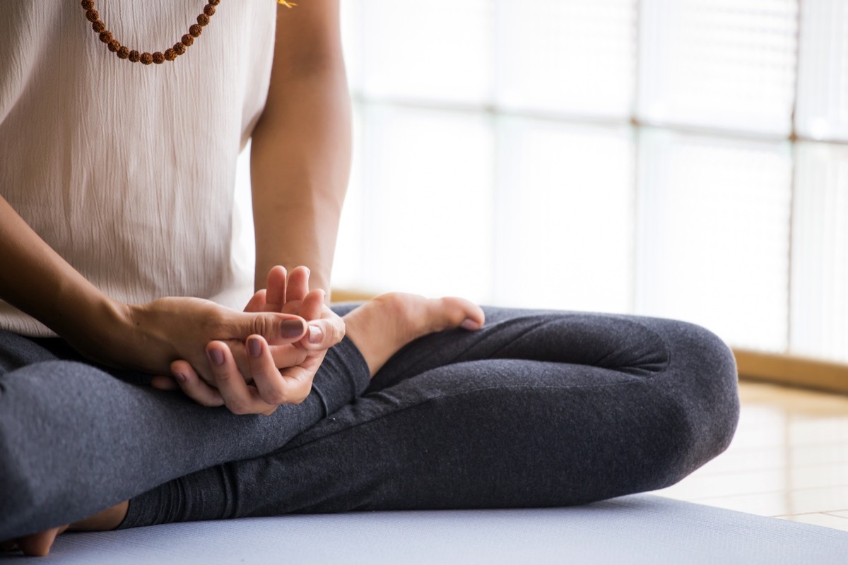 Woman meditating on the floor. 