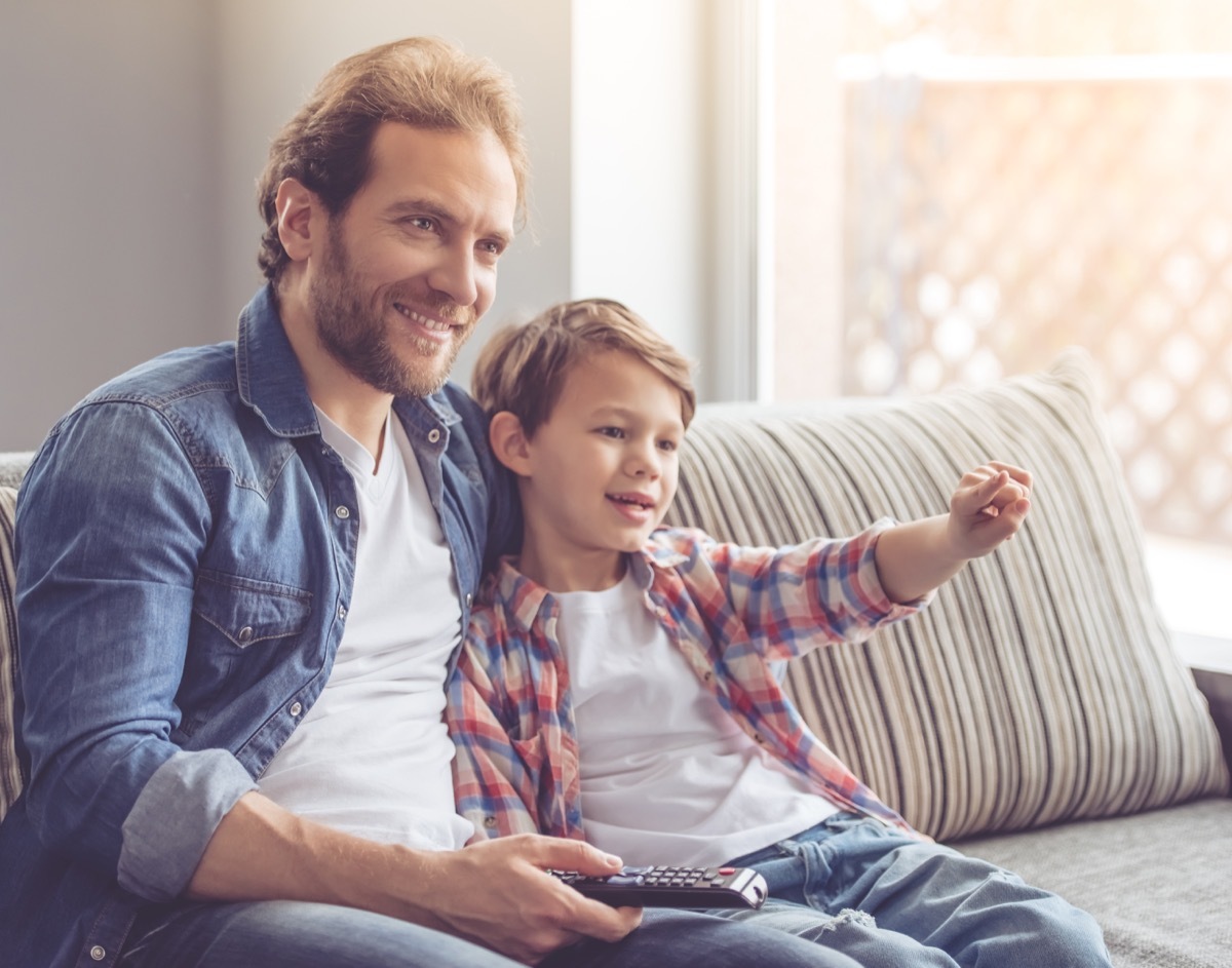 father and son watching tv