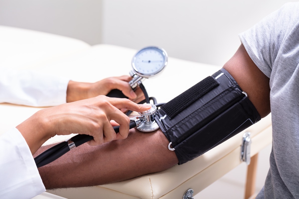 Doctor checking blood pressure