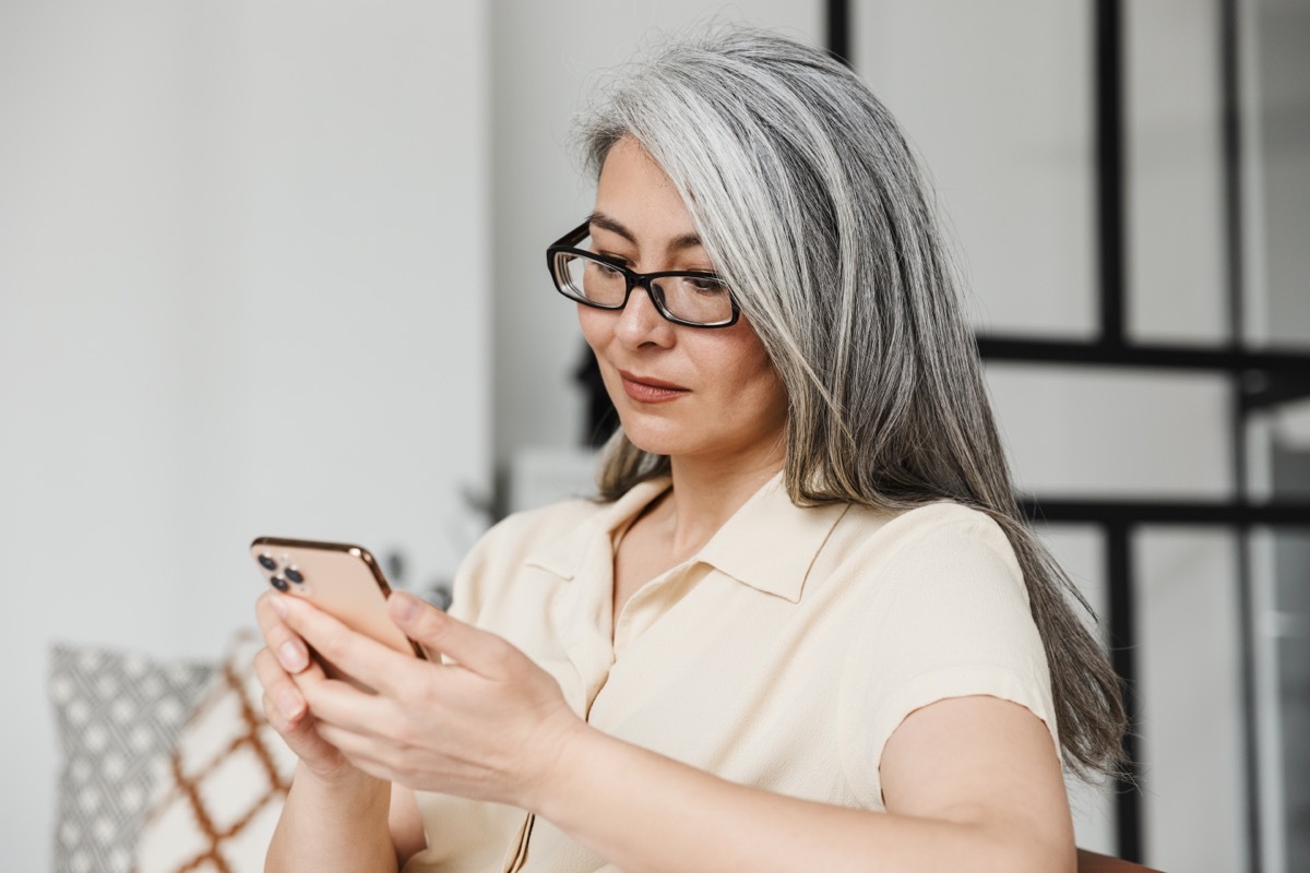 woman downloading app on phone