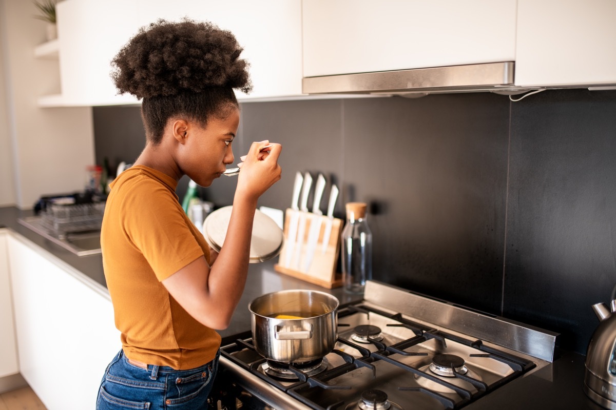 Young woman preparing her favorite soup