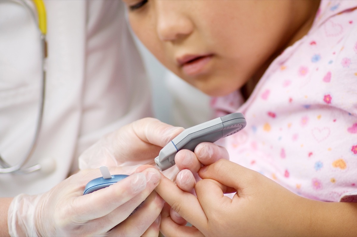 young child getting finger blood test