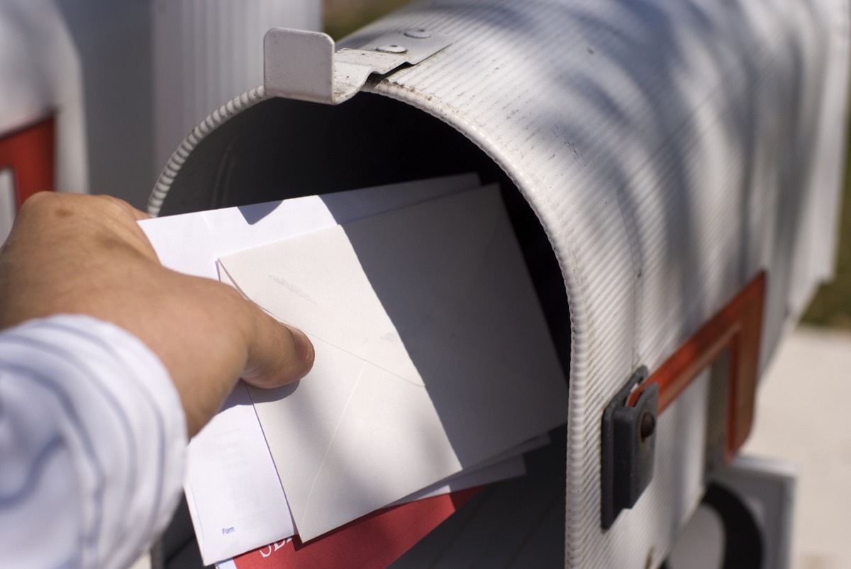 Male human hand getting the mail