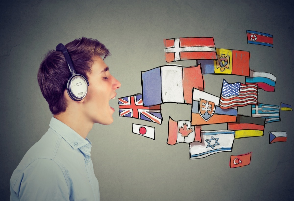 man speaking with flags of different countries