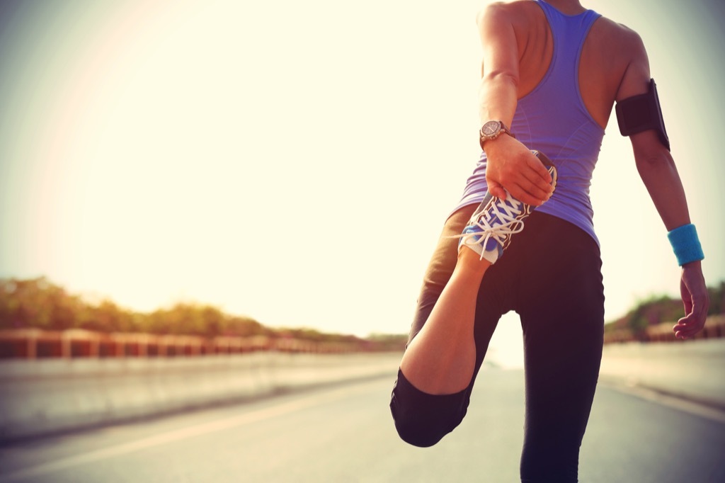 woman running run stretching exercise lies over 40