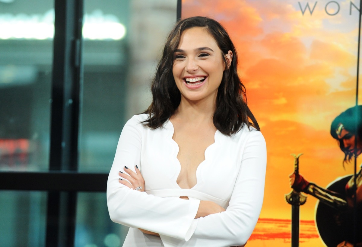 gal gadot laughing in white scalloped dress