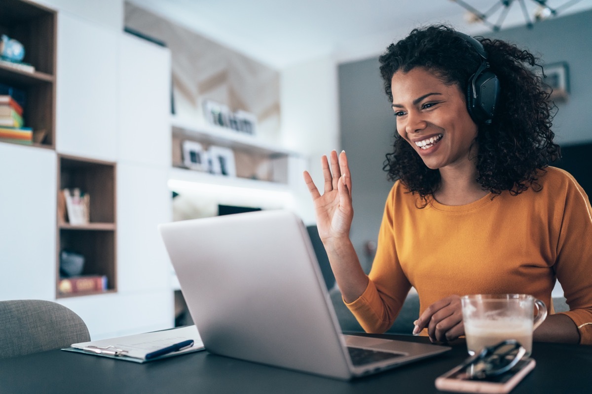 Young modern woman having Video Conference at home