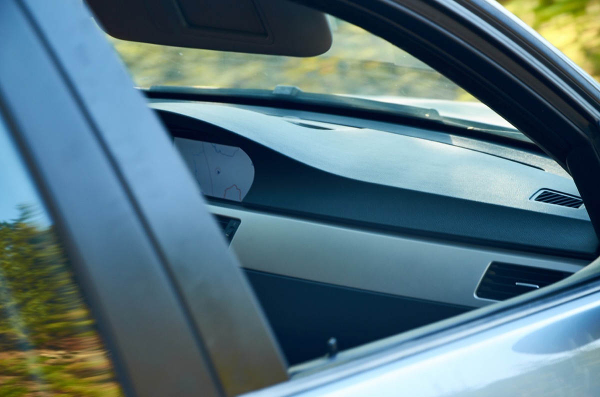 Part of a front car interior through an open window