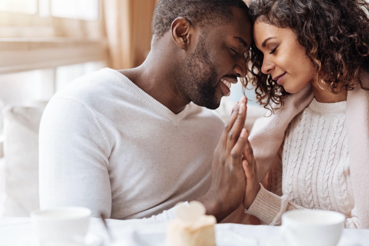 Man and woman cuddling dressed in white