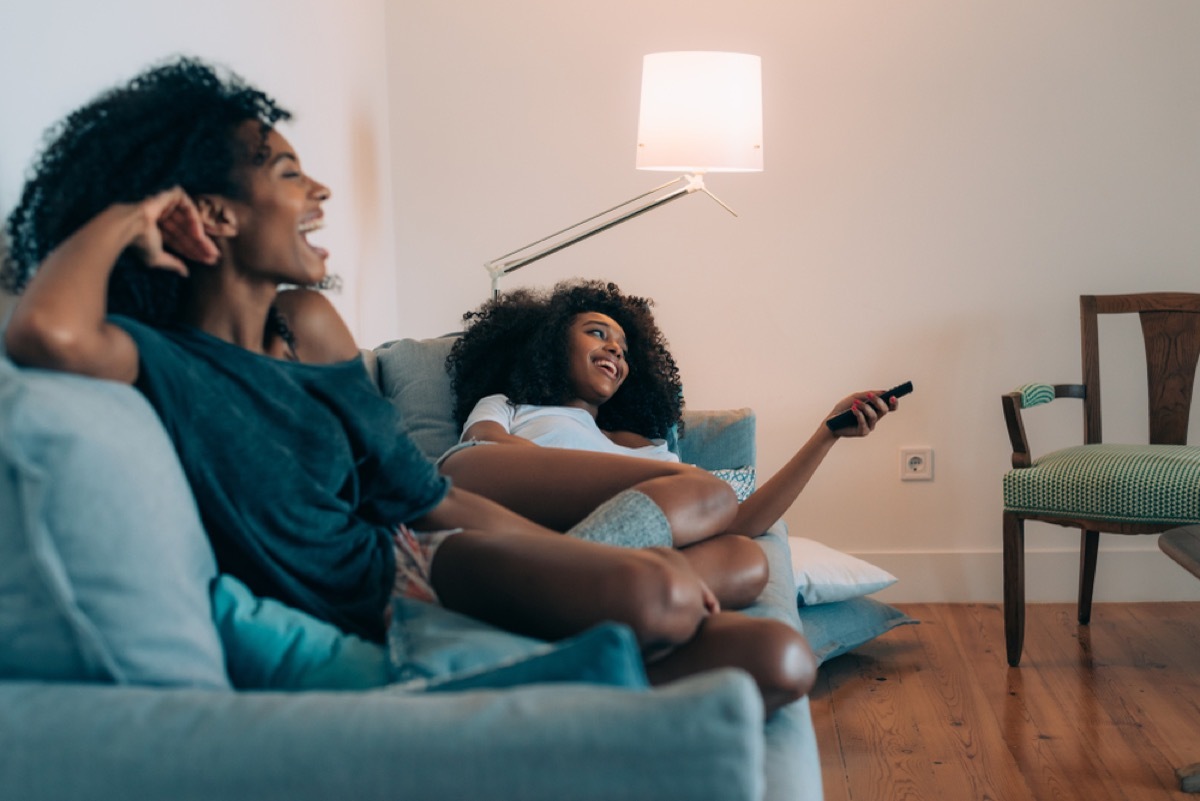 Two Black Women on Couch watching a movie