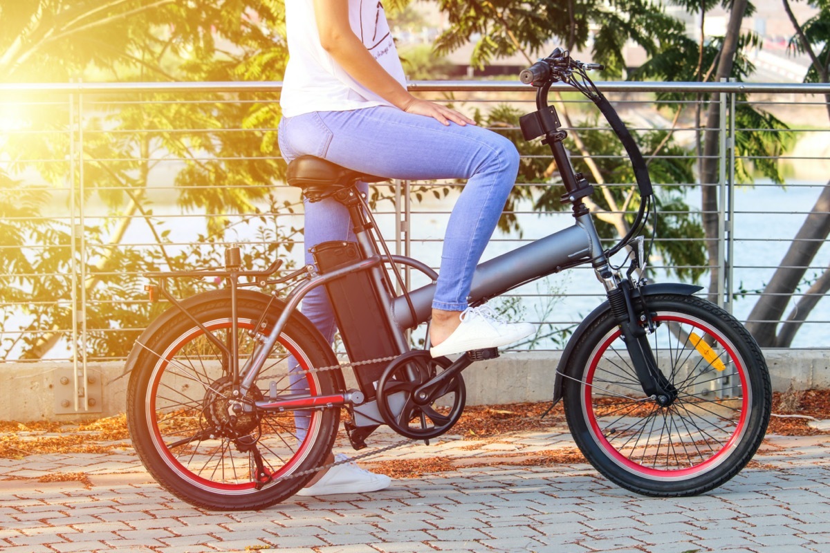 a woman rides an electric bike