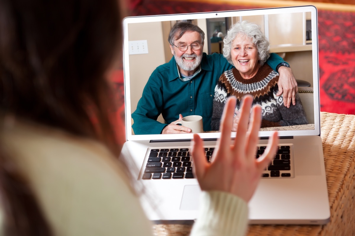 woman video chatting with older white couple