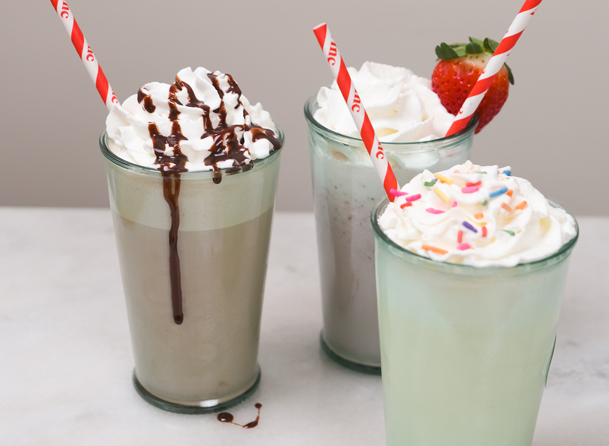 three types of milkshakes with red straws