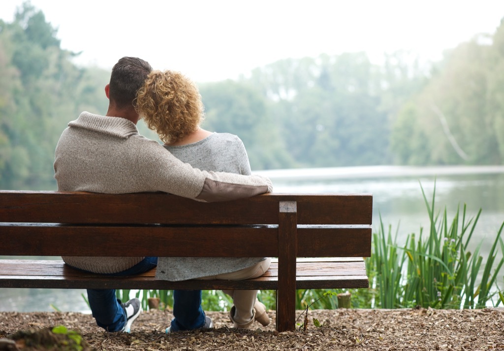 couple on a bench by a lake