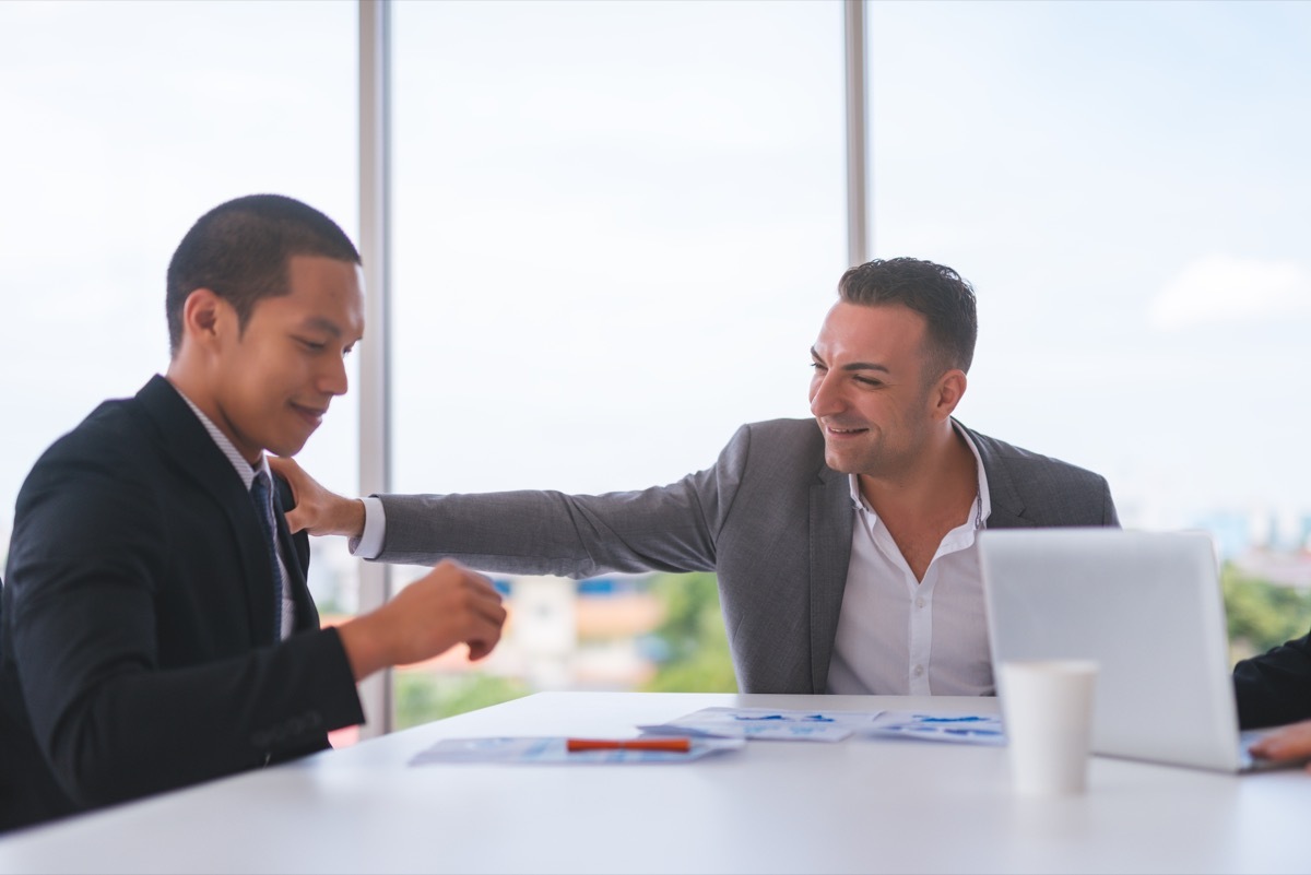 man complimenting coworker