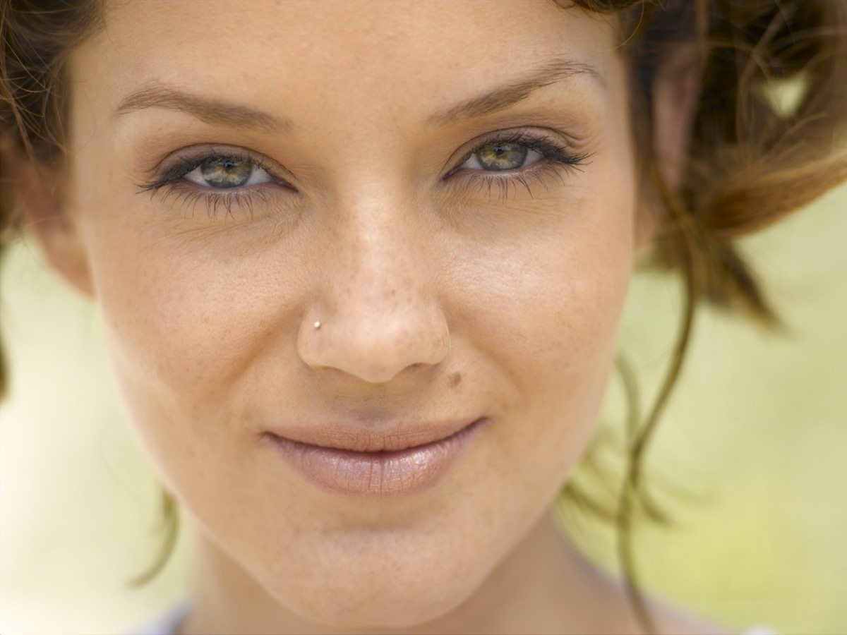 woman with red or brown hair and nose stud