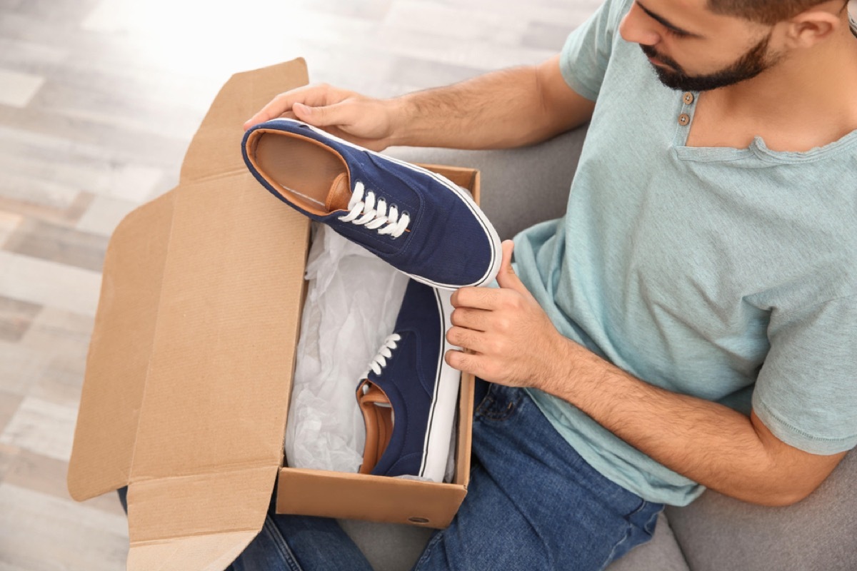 man taking shoes out of shoebox