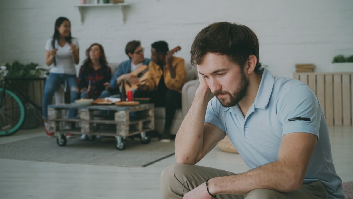 man sitting alone at a party