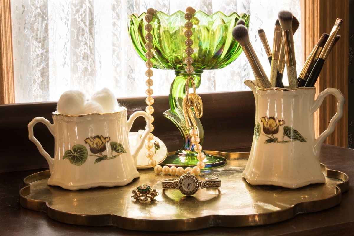 Repurposed mugs and tall bowl as jewelry and brush holder