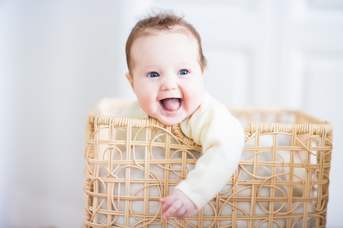 baby playing in hamper, bad parenting advice