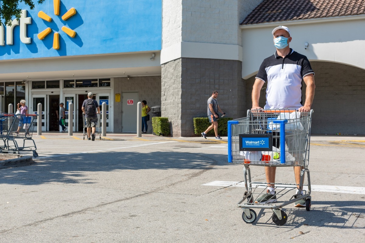 man in line leaving walmart