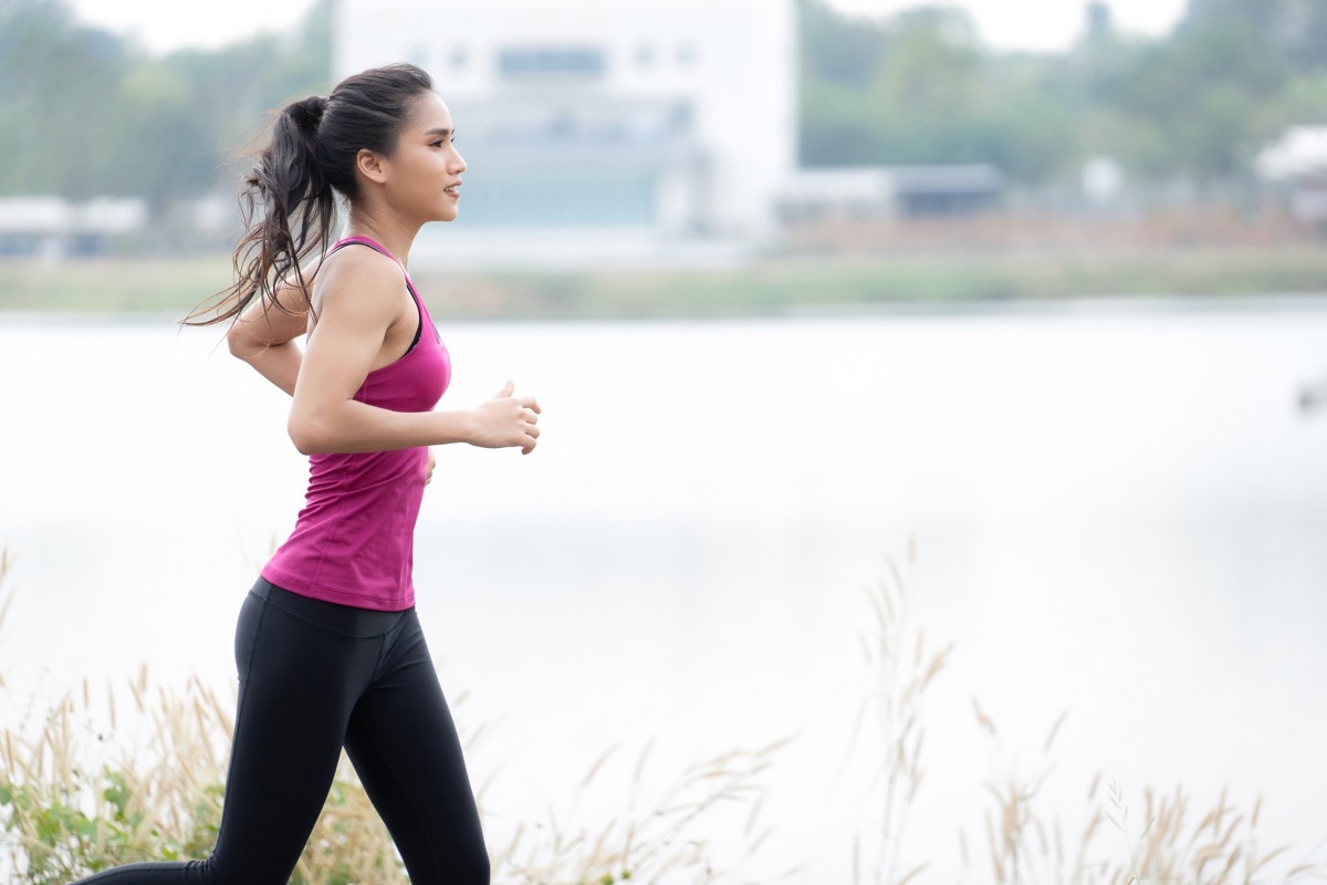 Woman running by water