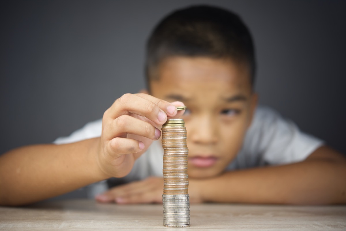 Young boy counting change coins