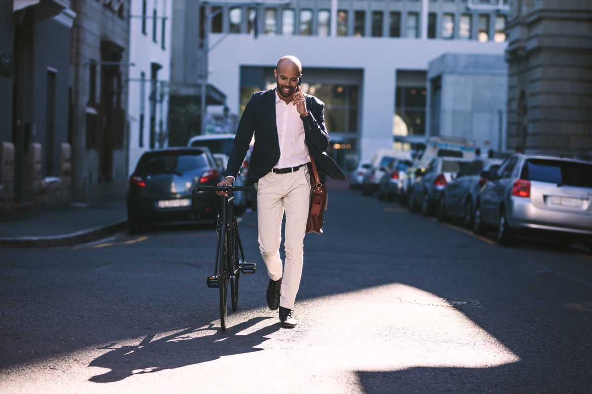 Man walking his bicycle to work