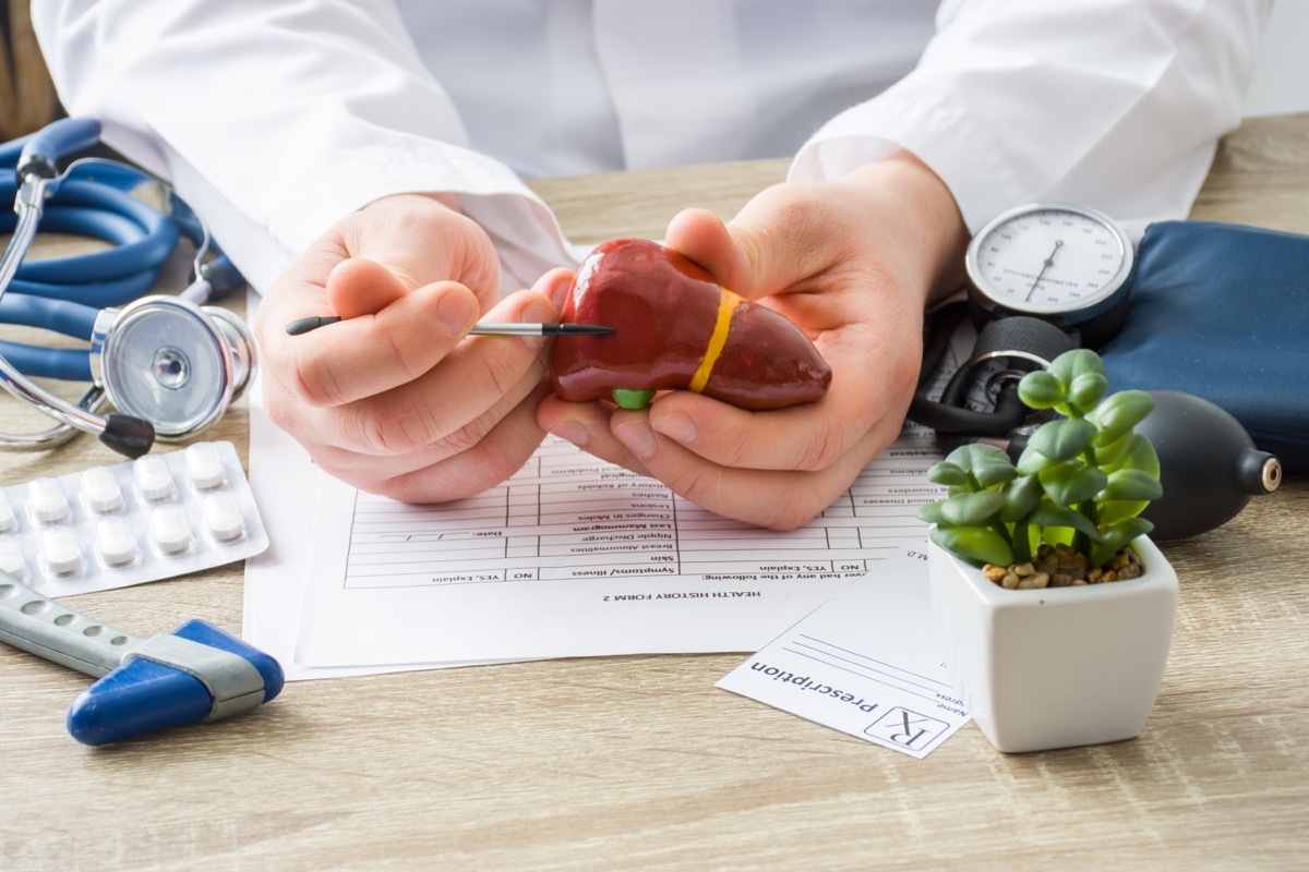 Doctor pointing at liver to explain liver disease to patient