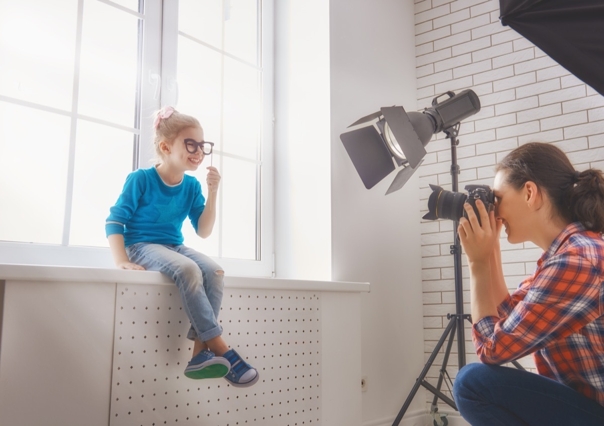 white mom photographing young daughter