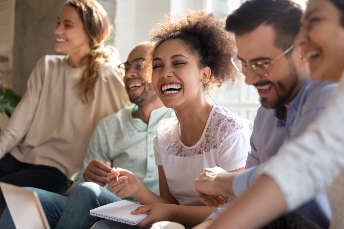 group of young people laughing while playing the 21 questions game