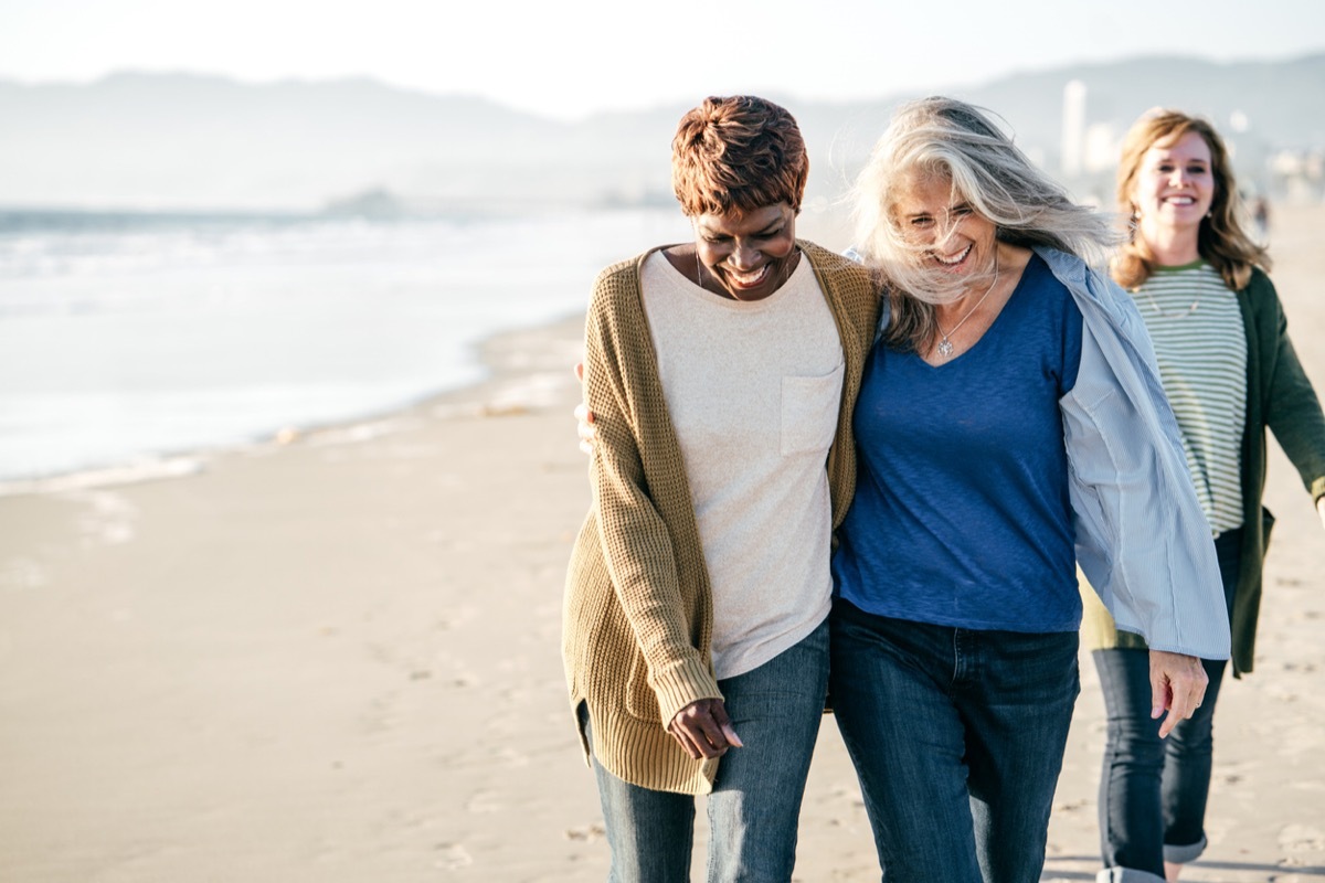 women walking on the beach in casual attire