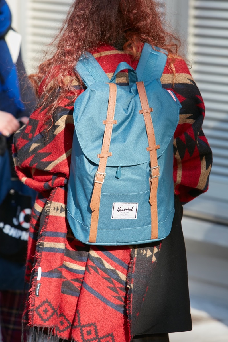 woman wearing herschel backpack coolest school accessory every year