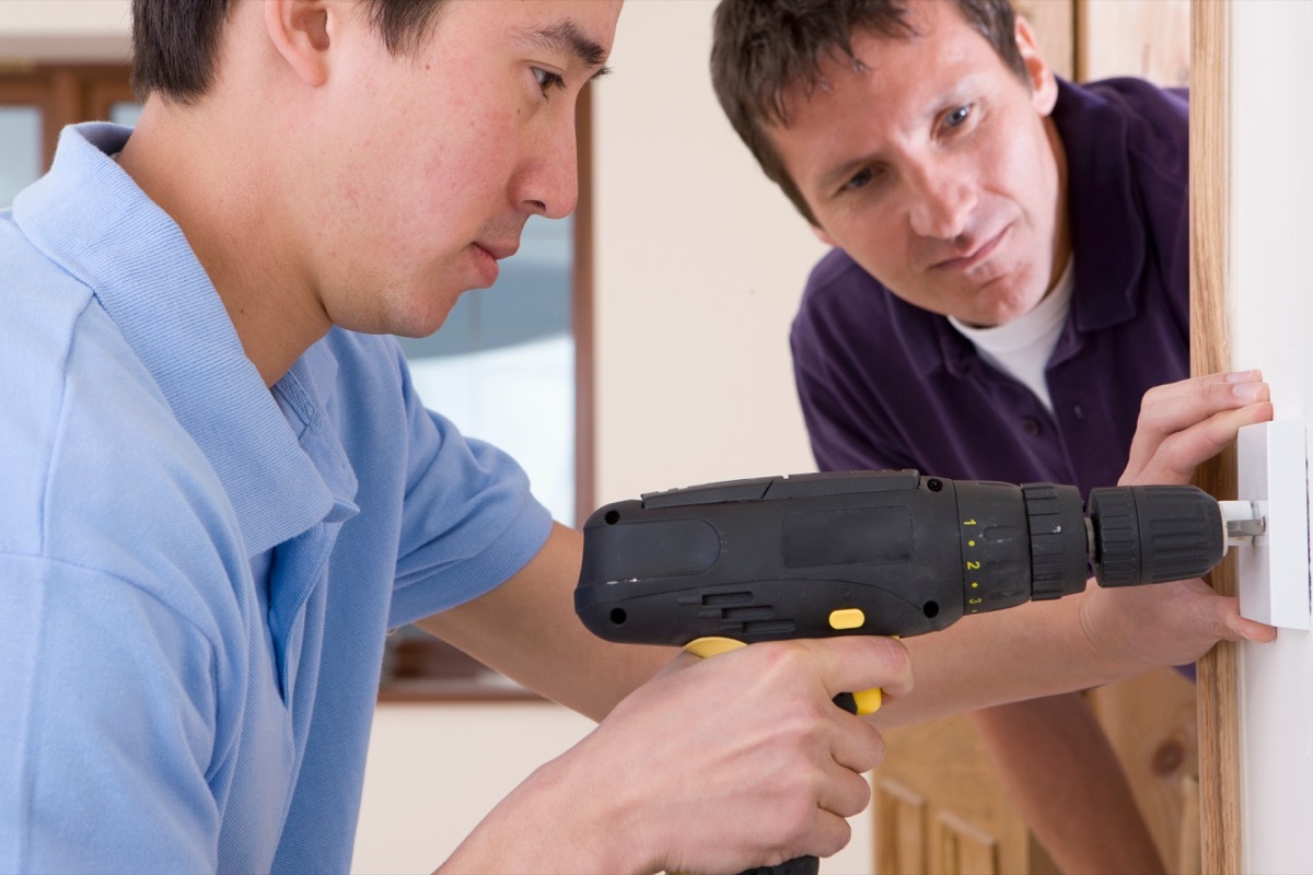 asian man installing outlet