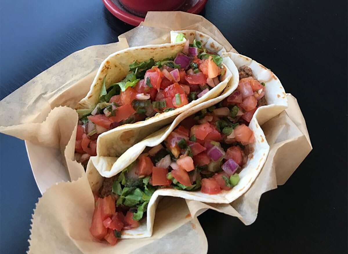 two tacos topped with pico de gallo