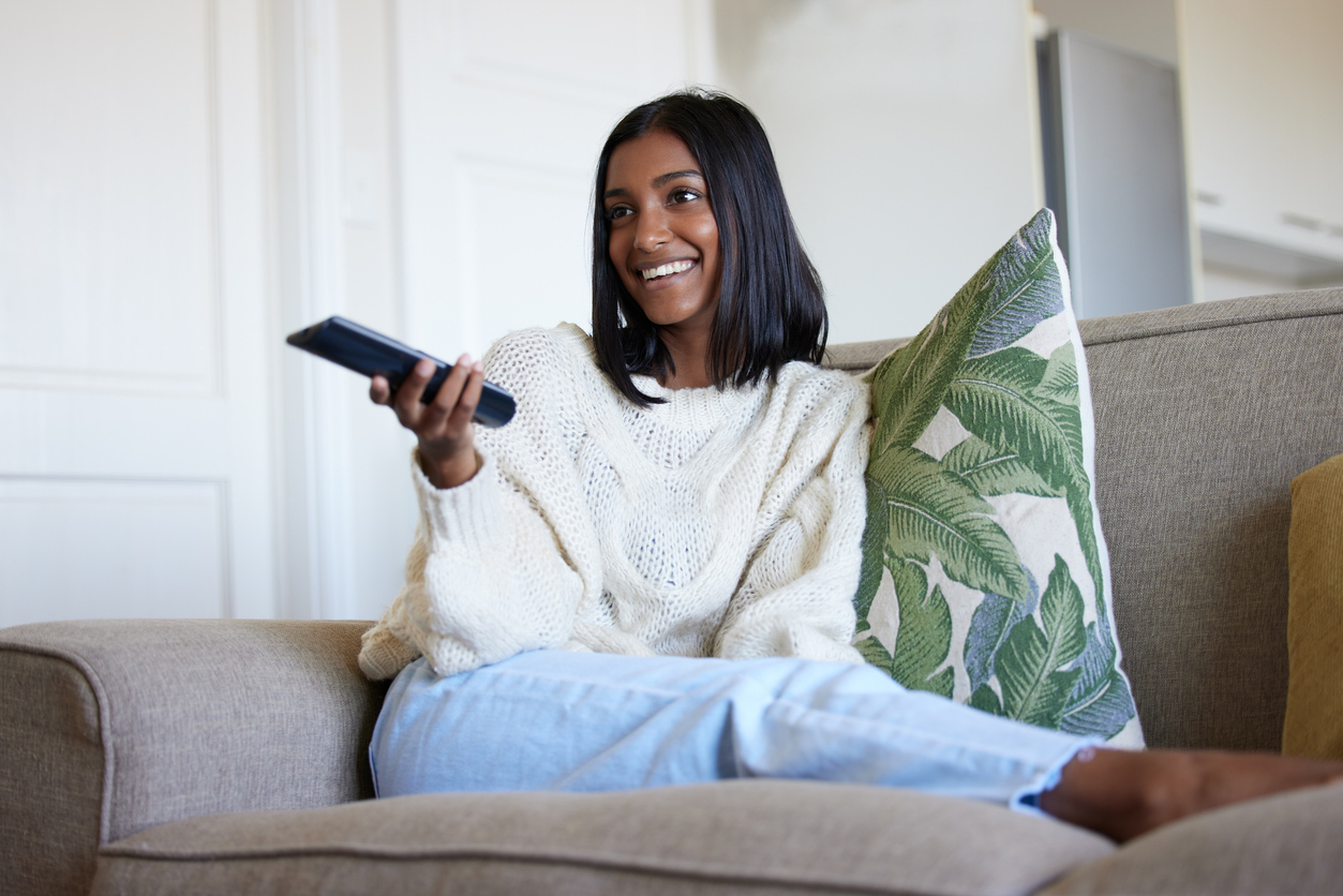 beautiful young woman watching netflix 