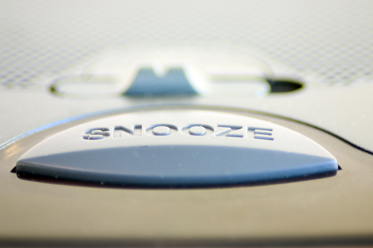 closeup of snooze button on alarm clock