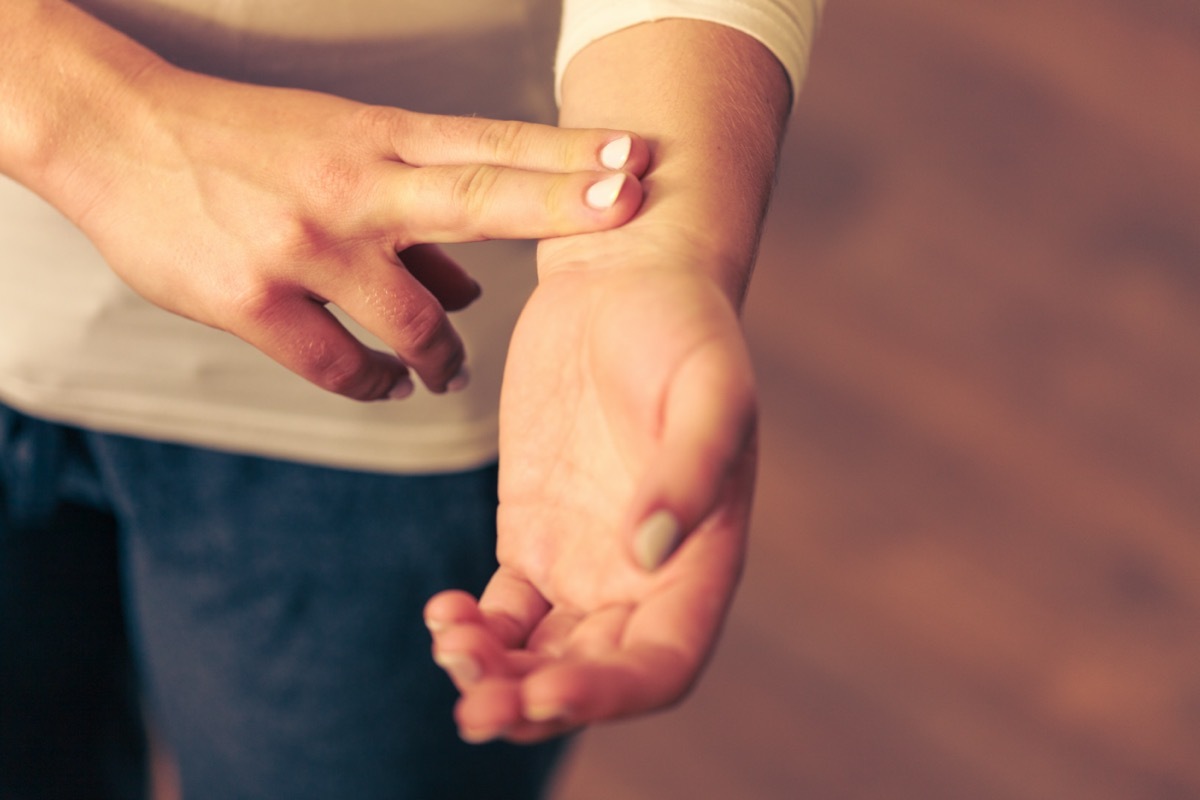 Medicine health care. Female hand checking pulse on wrist closeup.