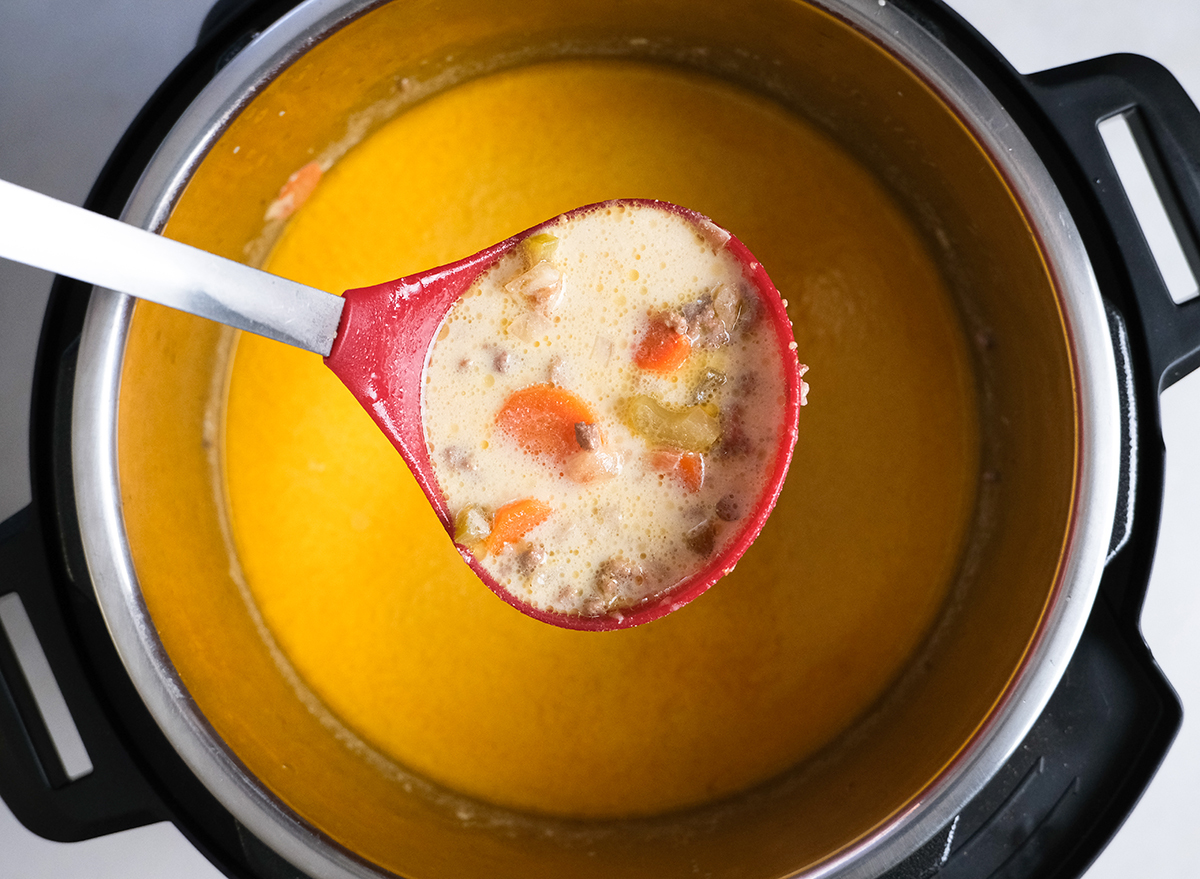 scooping cheeseburger soup out of an Instant Pot