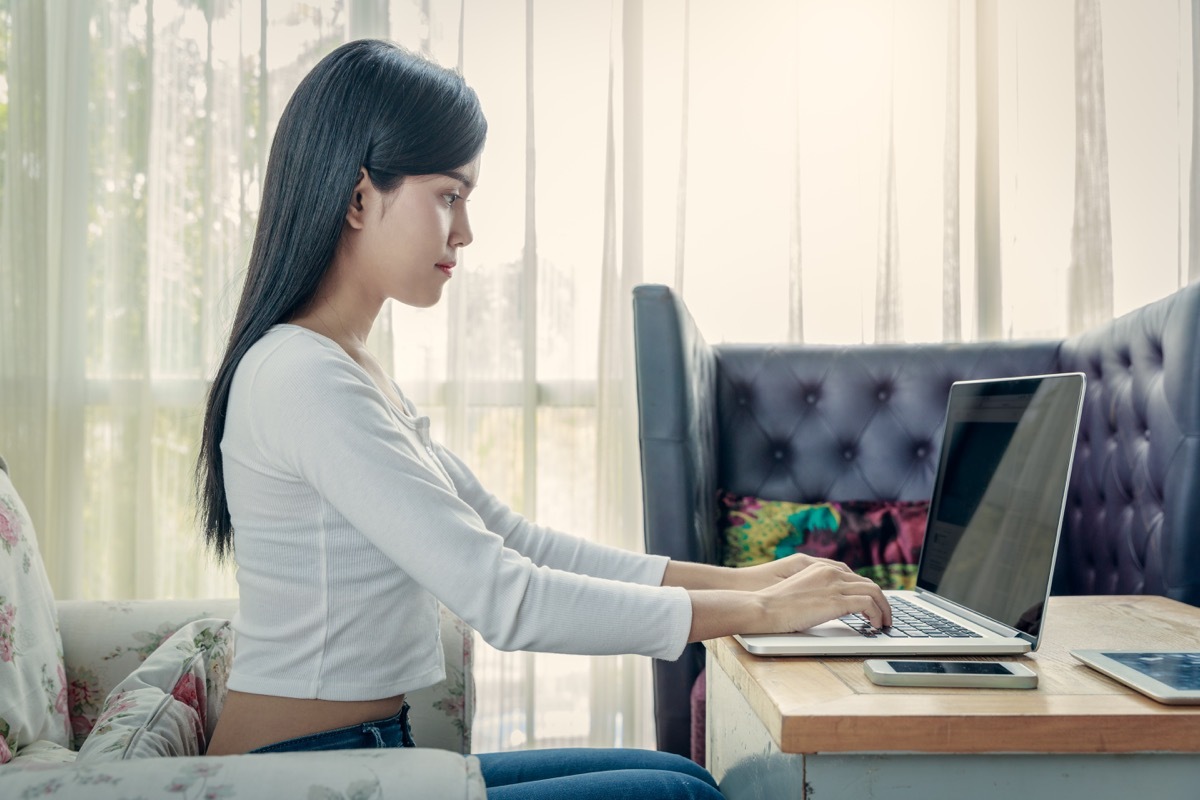 woman sitting up straight while using her laptop