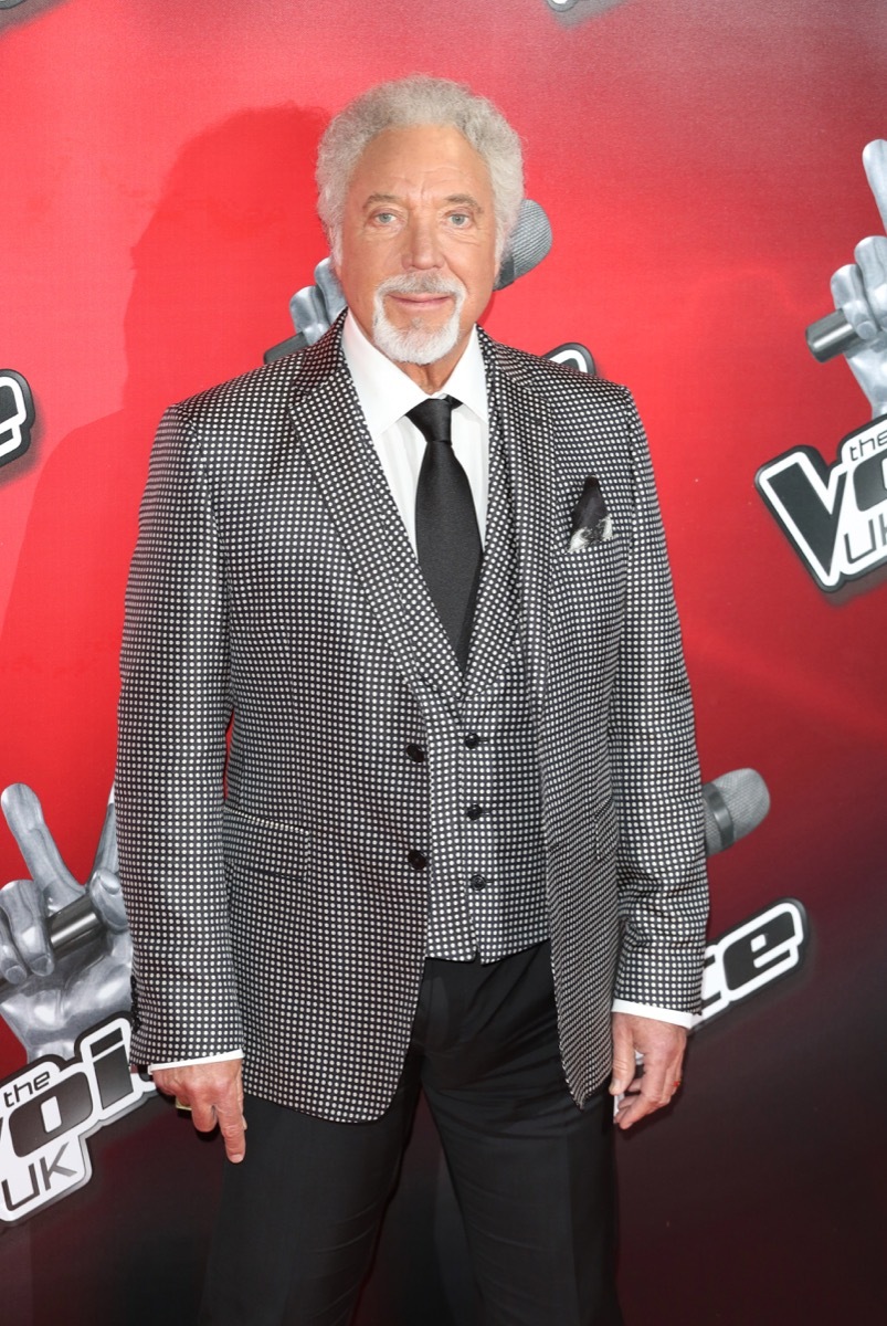 Tom Jones stands in grey three piece suit with grey hair, offended by Prince Philip among his controversial moments