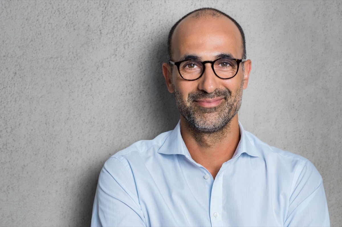 man wearing glasses on grey background