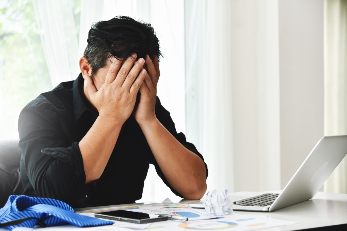 Stressed man head in hands