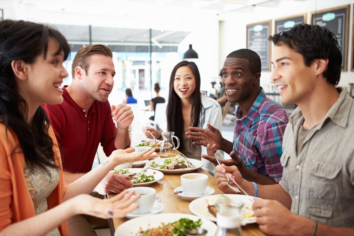 Two women and three men having lunch and talking