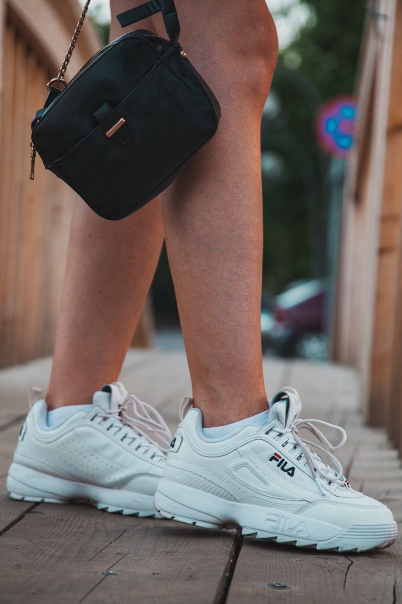 Person wearing trendy fila sneakers