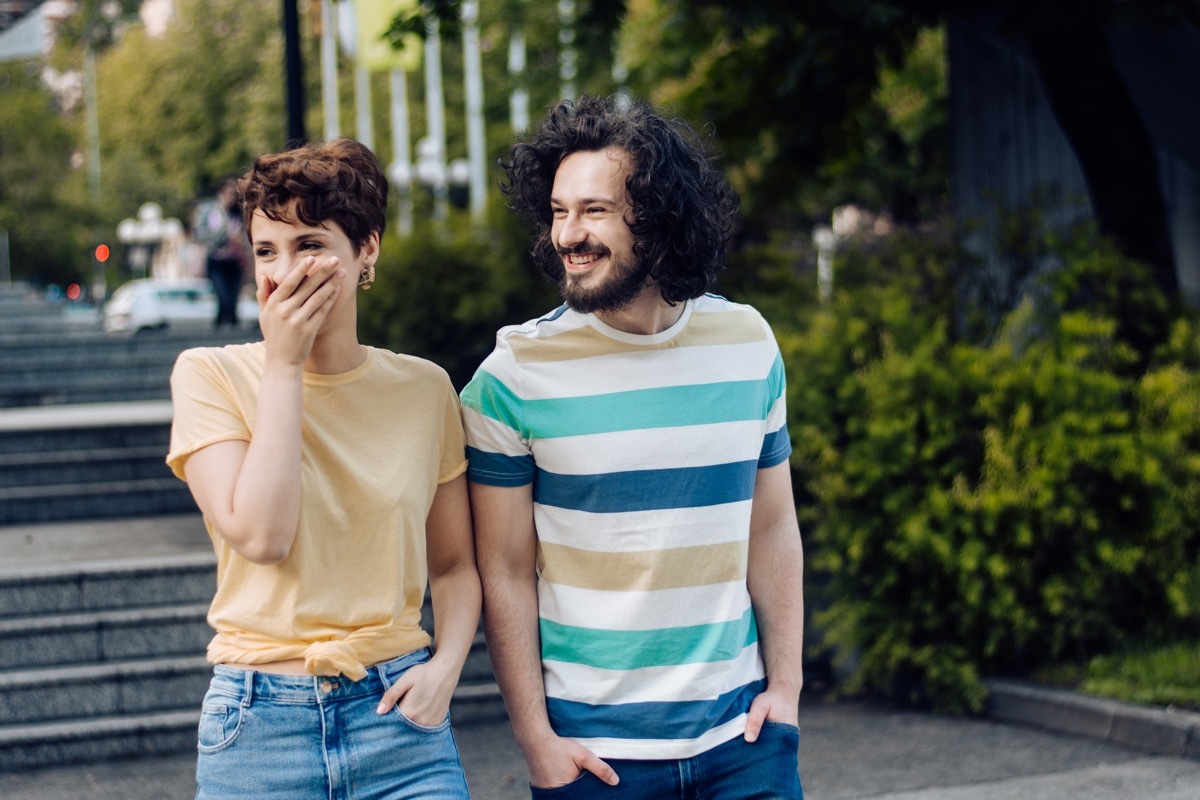 Young couple on vacation, walking through the city and having fun together.