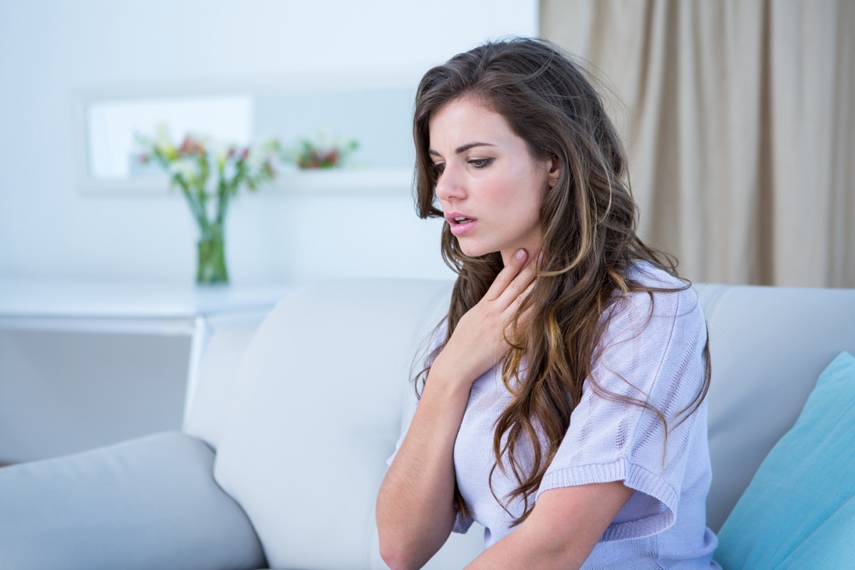 woman doing asthma crisis at home in the living room