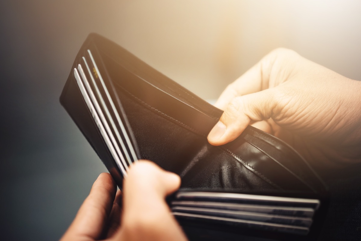 man showing empty wallet