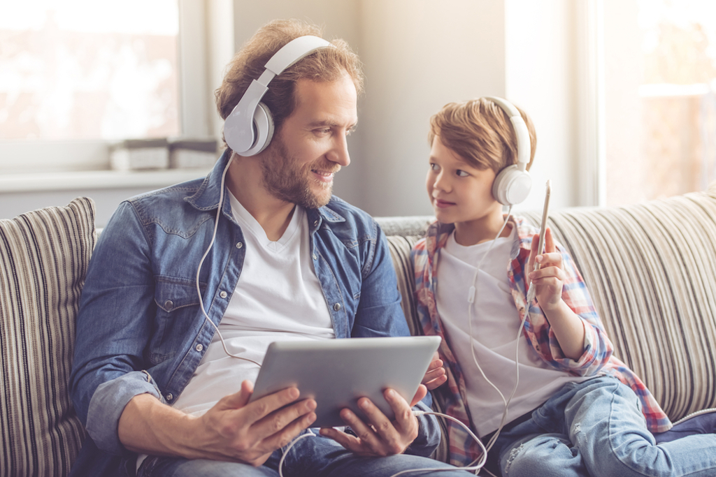 father and son listen to music together