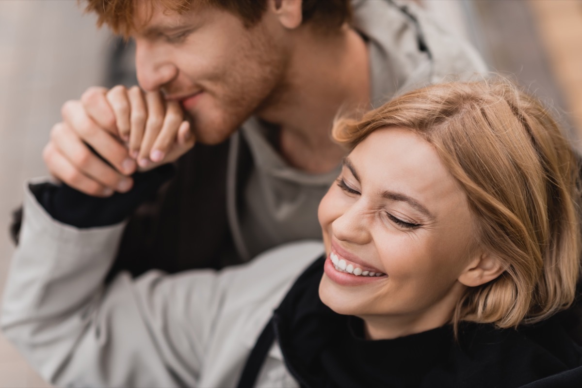 man kissing girlfriend's hand